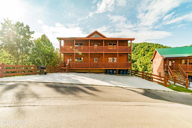 exterior space with fence and a balcony