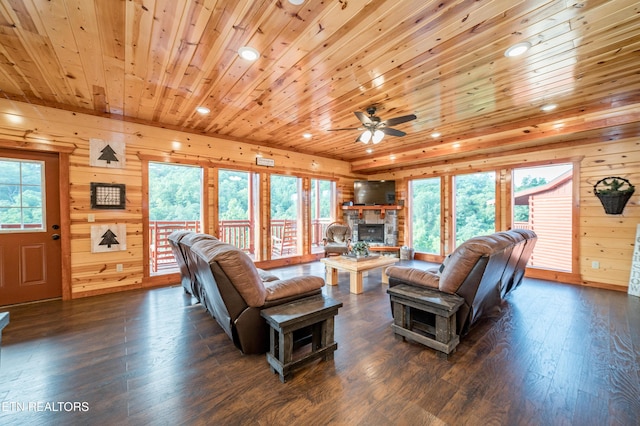 living area with recessed lighting, dark wood-type flooring, wood walls, a fireplace, and wood ceiling