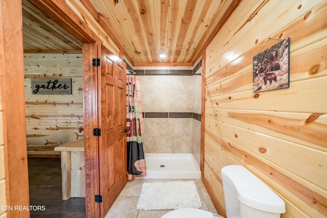 bathroom with toilet, wooden ceiling, a shower stall, and wooden walls