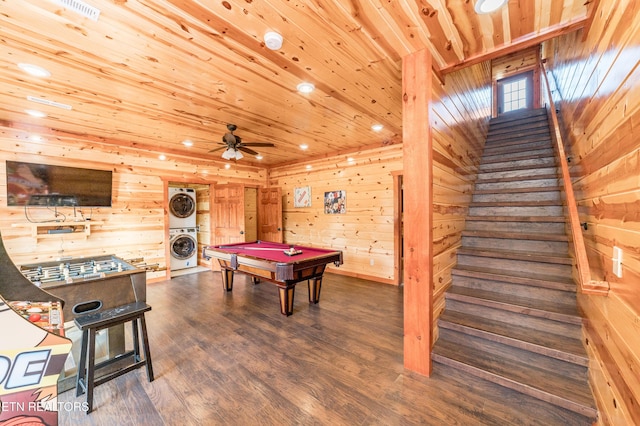 rec room featuring stacked washer and clothes dryer, dark wood finished floors, wood walls, wooden ceiling, and billiards