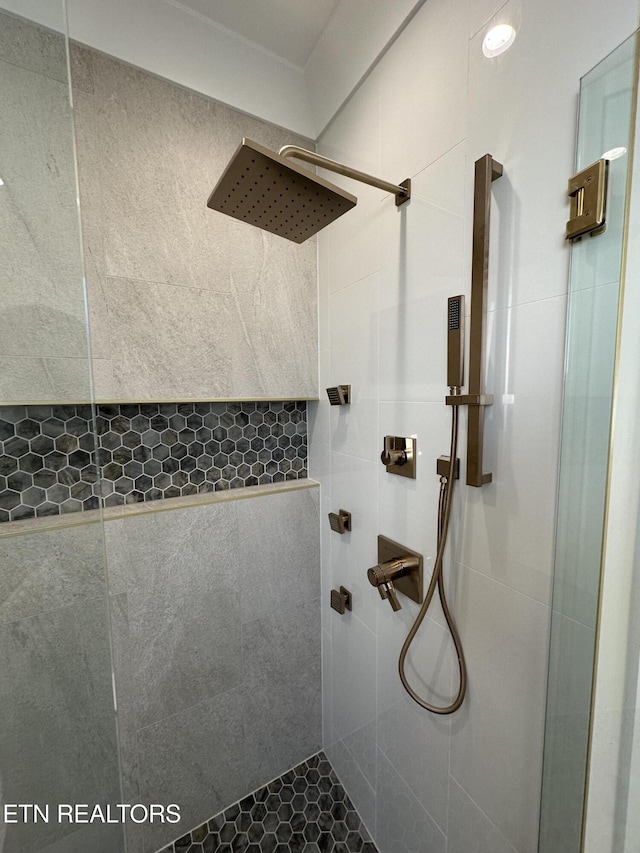 full bath with a tile shower