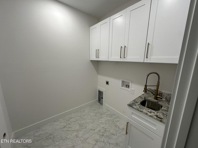 laundry area with hookup for an electric dryer, a sink, baseboards, marble finish floor, and cabinet space