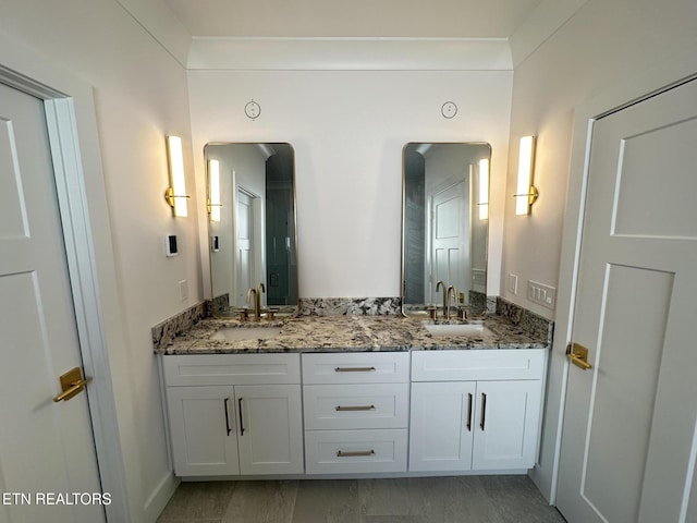 bathroom featuring double vanity and a sink