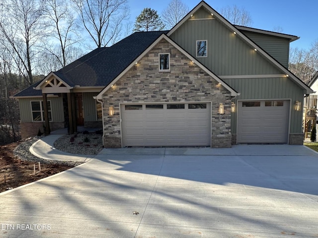 view of front facade featuring concrete driveway, an attached garage, board and batten siding, and roof with shingles