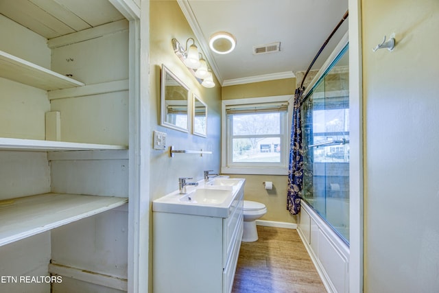 full bath with visible vents, toilet, ornamental molding, vanity, and wood finished floors