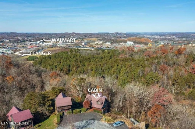 drone / aerial view featuring a forest view