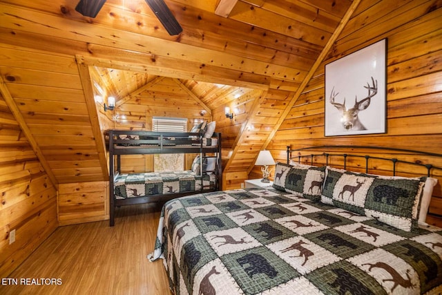 bedroom featuring wood ceiling, vaulted ceiling, wood walls, and wood finished floors