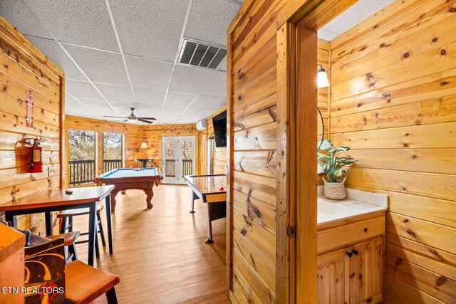 recreation room featuring a paneled ceiling, wooden walls, billiards, wood finished floors, and visible vents