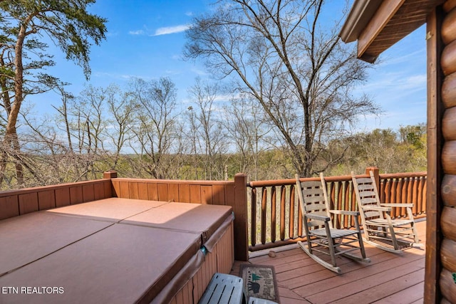 wooden terrace featuring a hot tub