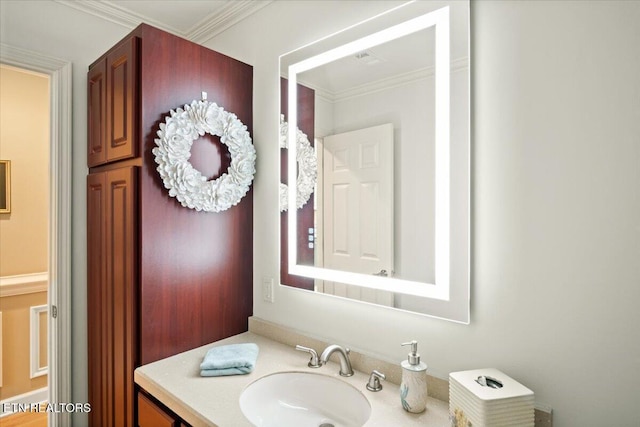 bathroom with ornamental molding and vanity