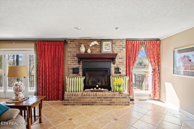 living area with a brick fireplace, crown molding, a textured ceiling, and baseboards