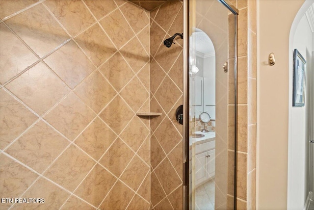 bathroom with a shower stall and vanity