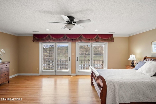 bedroom with access to exterior, visible vents, and wood finished floors