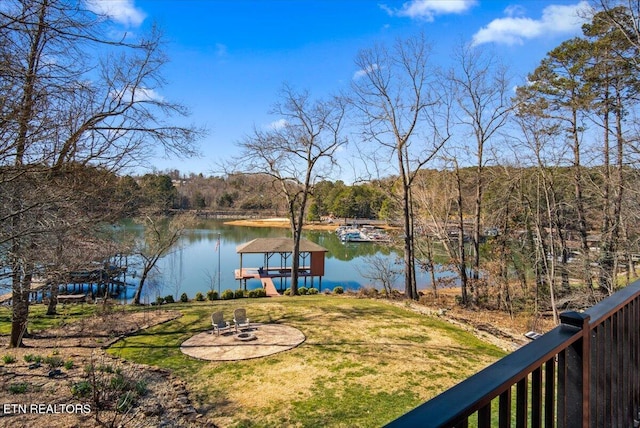 exterior space featuring an outdoor fire pit and a boat dock