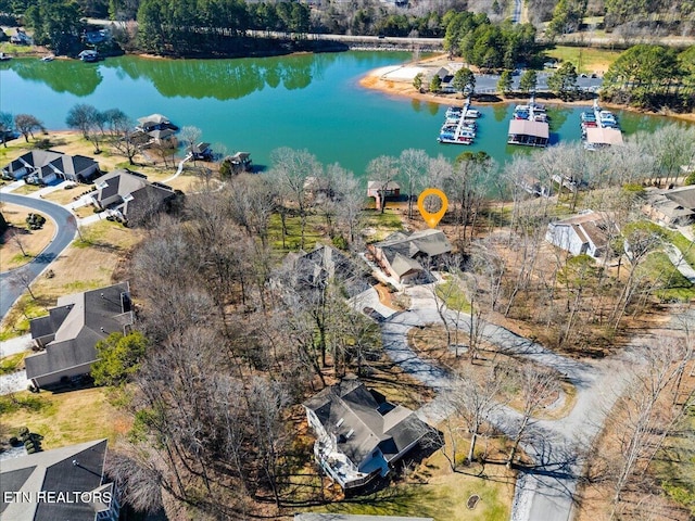 drone / aerial view featuring a residential view and a water view