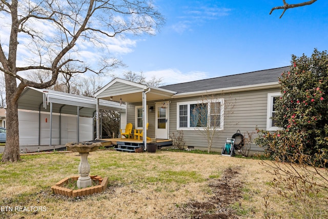 view of front facade with a front lawn, crawl space, and a detached carport