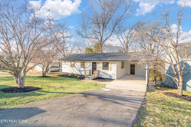 single story home featuring driveway, a front lawn, and an attached carport