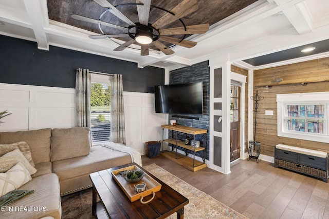 living room with coffered ceiling, beamed ceiling, and wood finished floors