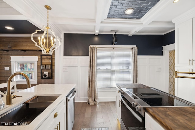 kitchen with coffered ceiling, dishwasher, electric stove, beam ceiling, and a sink