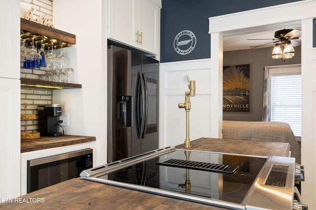 kitchen featuring wine cooler, wood counters, a ceiling fan, white cabinets, and stainless steel refrigerator with ice dispenser