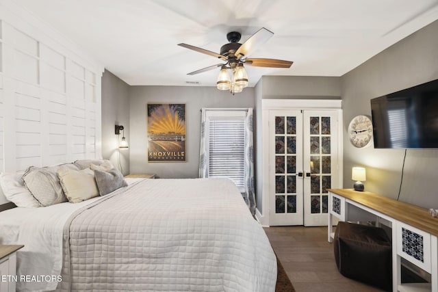 bedroom featuring ceiling fan, visible vents, dark wood-type flooring, and french doors