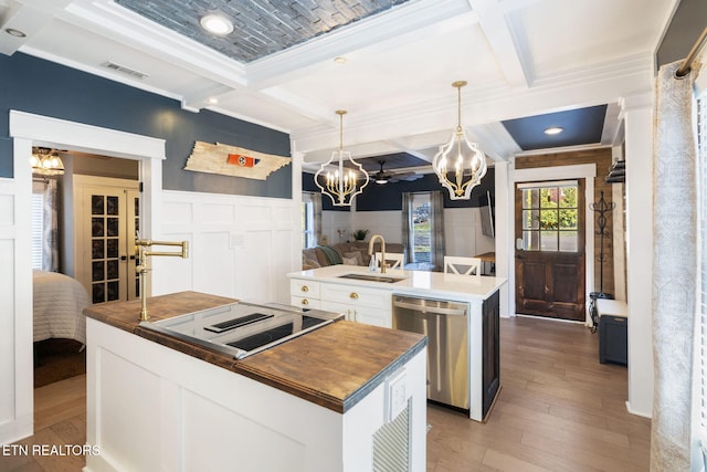 kitchen featuring visible vents, coffered ceiling, dishwasher, a kitchen island with sink, and a sink