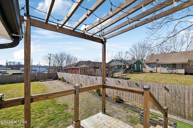 wooden deck with a fenced backyard, a pergola, and a yard