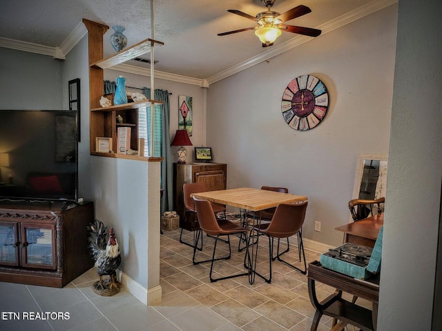 tiled dining space with crown molding, baseboards, and ceiling fan