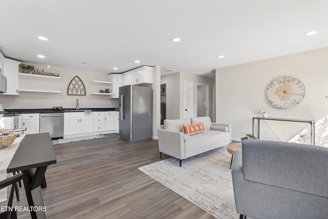 living area with recessed lighting, dark wood-style flooring, and baseboards