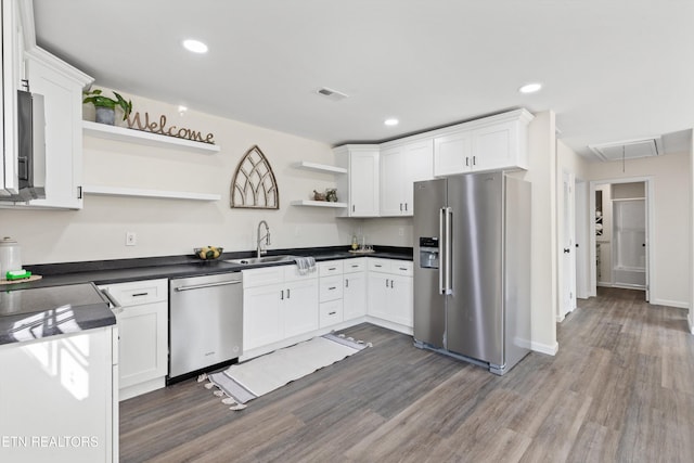 kitchen with dark wood-style floors, open shelves, appliances with stainless steel finishes, and white cabinetry