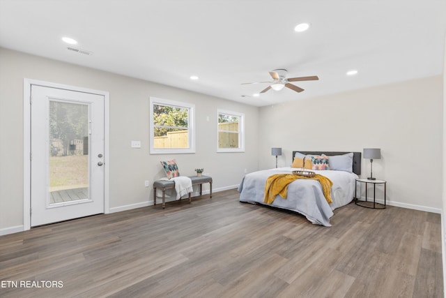 bedroom featuring recessed lighting, wood finished floors, visible vents, baseboards, and access to outside