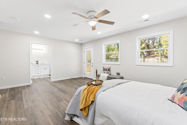 bedroom with recessed lighting, wood finished floors, visible vents, baseboards, and access to outside