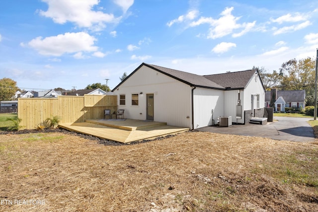 back of house featuring a deck and central air condition unit