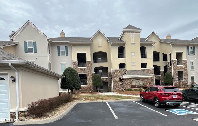 view of building exterior with uncovered parking