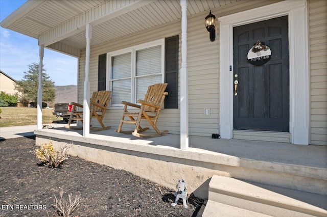 entrance to property featuring a porch