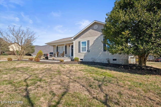 view of front facade with a porch, crawl space, and a front lawn