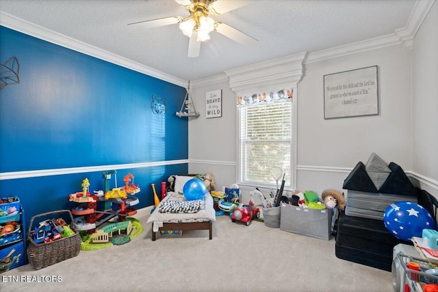 rec room featuring carpet, crown molding, a textured ceiling, and ceiling fan