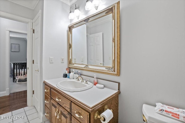 half bathroom with toilet, tile patterned flooring, and vanity