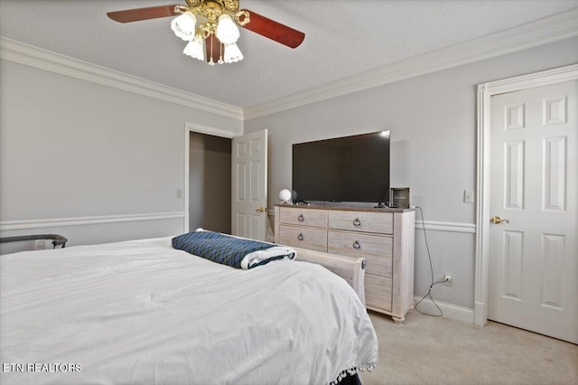 bedroom featuring ceiling fan, a textured ceiling, light carpet, baseboards, and crown molding