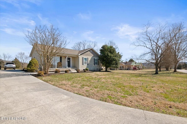 view of front facade featuring crawl space, covered porch, and a front lawn