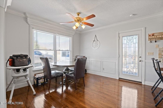 dining area featuring ornamental molding and wood finished floors