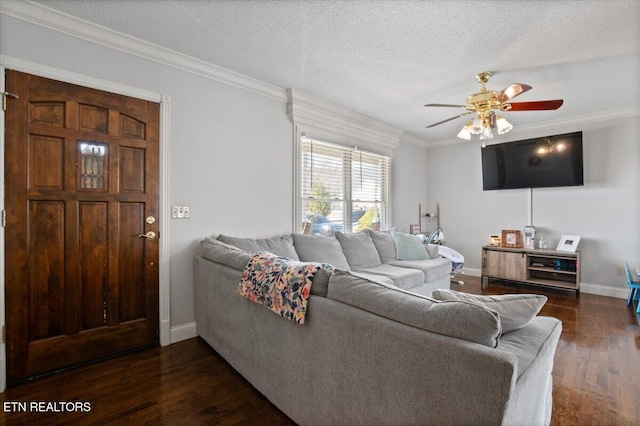 living room with ornamental molding, dark wood-style flooring, a textured ceiling, and a ceiling fan