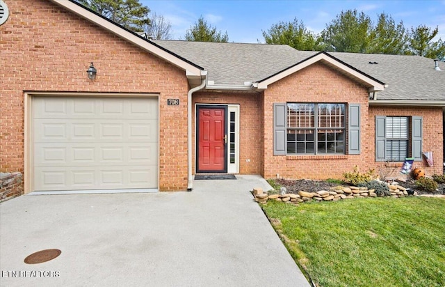 single story home featuring concrete driveway, a shingled roof, an attached garage, and brick siding