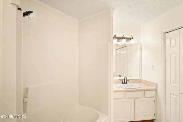 full bath featuring ornamental molding, a textured ceiling, and vanity