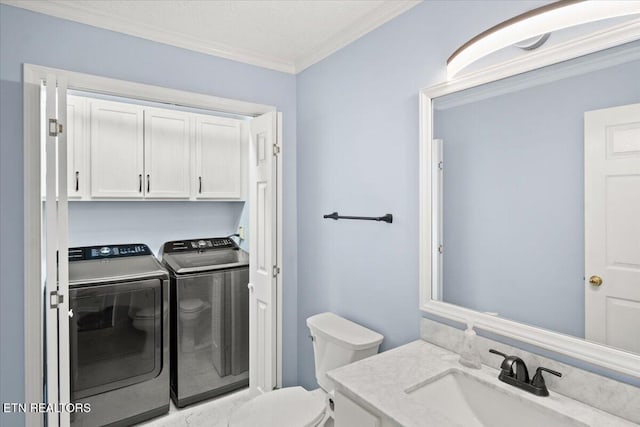 bathroom with vanity, ornamental molding, washing machine and clothes dryer, and toilet