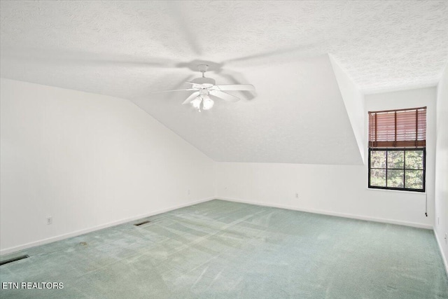 additional living space with lofted ceiling, carpet flooring, visible vents, and baseboards