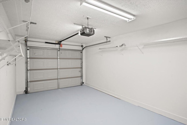 garage with baseboards and a garage door opener