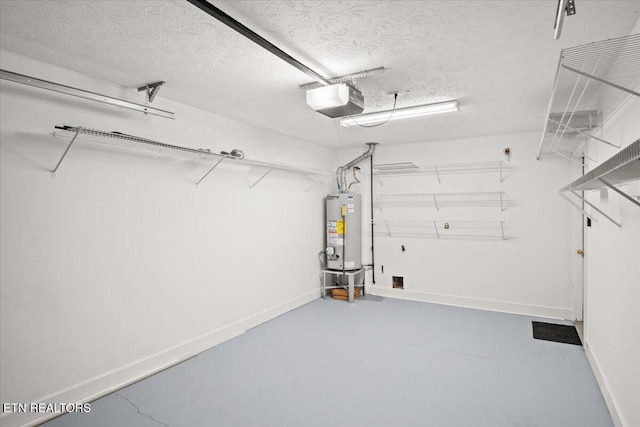 garage featuring a garage door opener, water heater, and baseboards