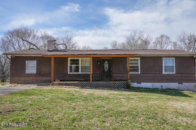 view of front of house featuring roof with shingles, a front lawn, crawl space, and a chimney