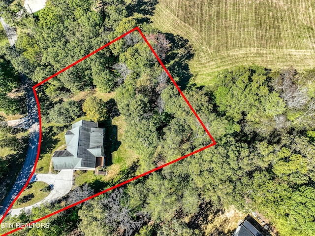 birds eye view of property with a forest view